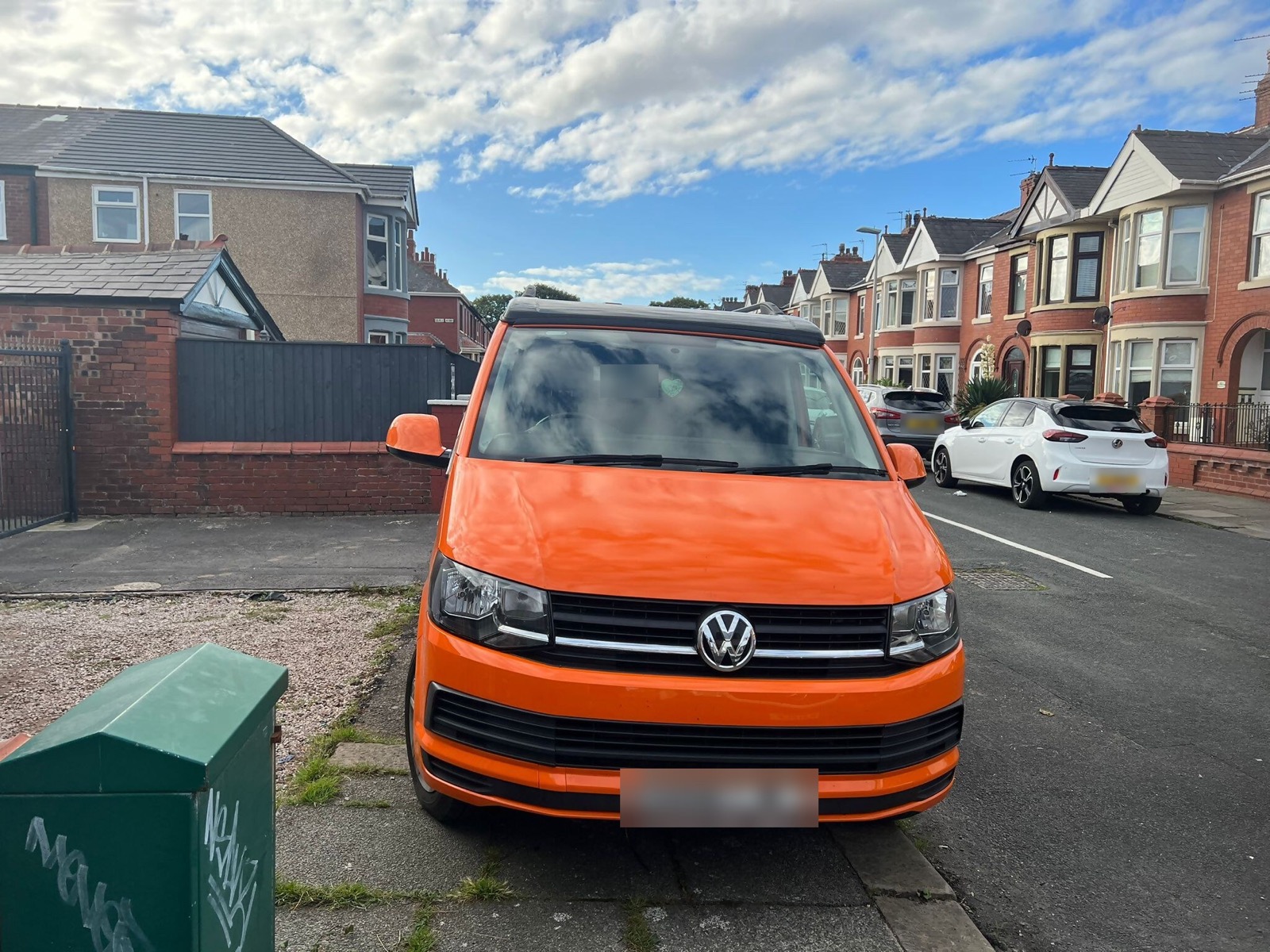 Orange VW van conversion viewed from the front